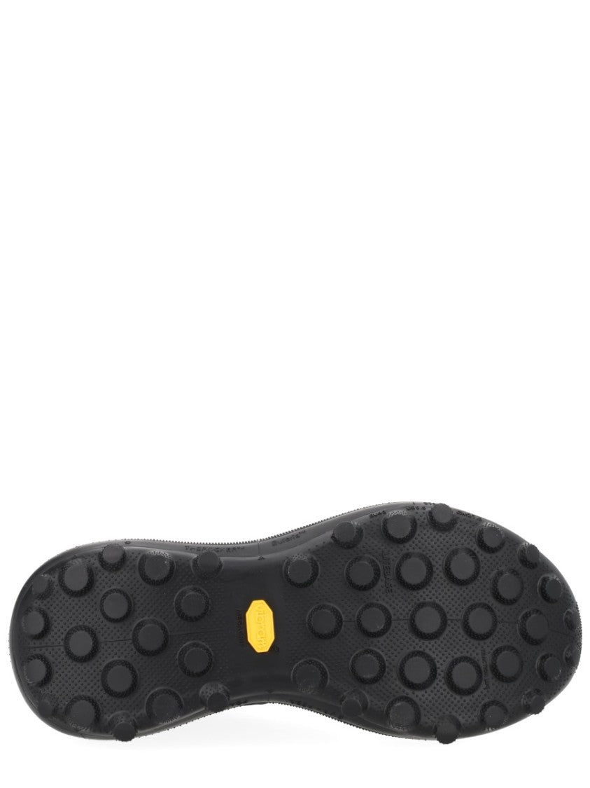 Satisfy Streamlined Black Sneakers With Rugged Tread And Textural Details