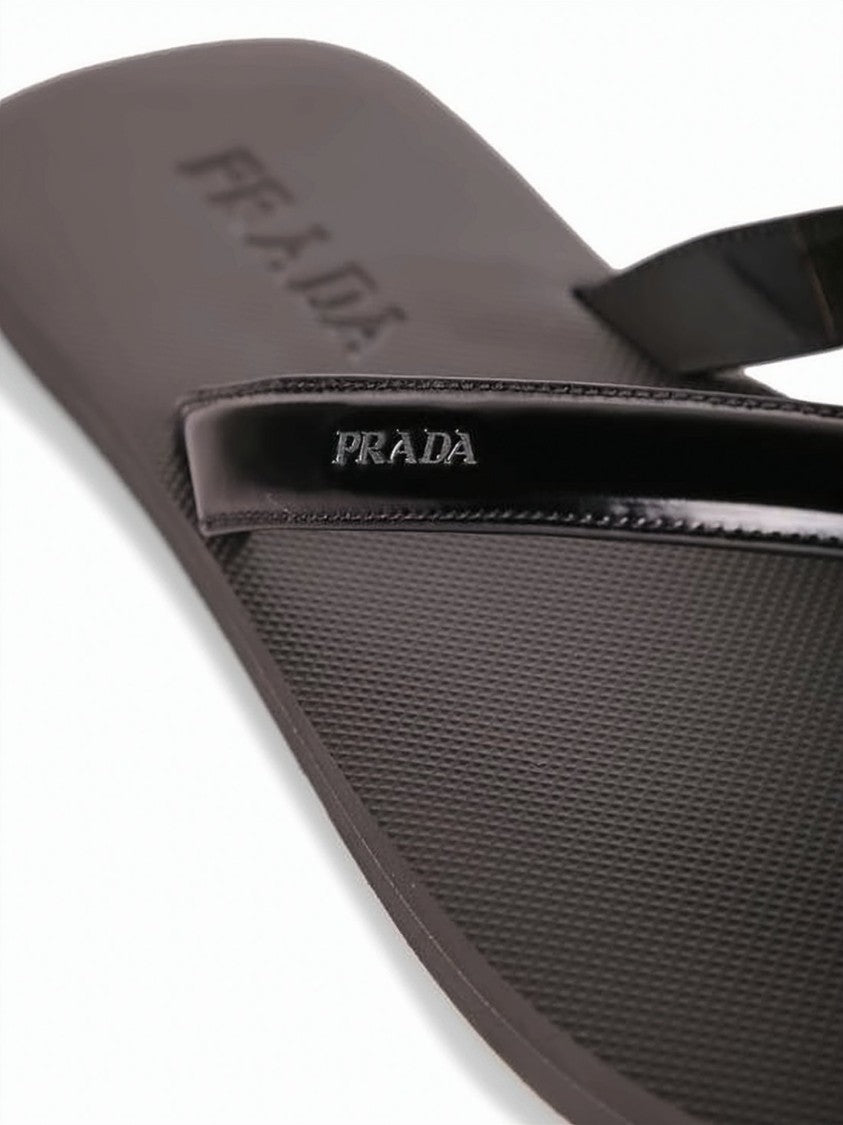Prada Minimalist Slip-On Sandals With Textured Footbed And Glossy Strap