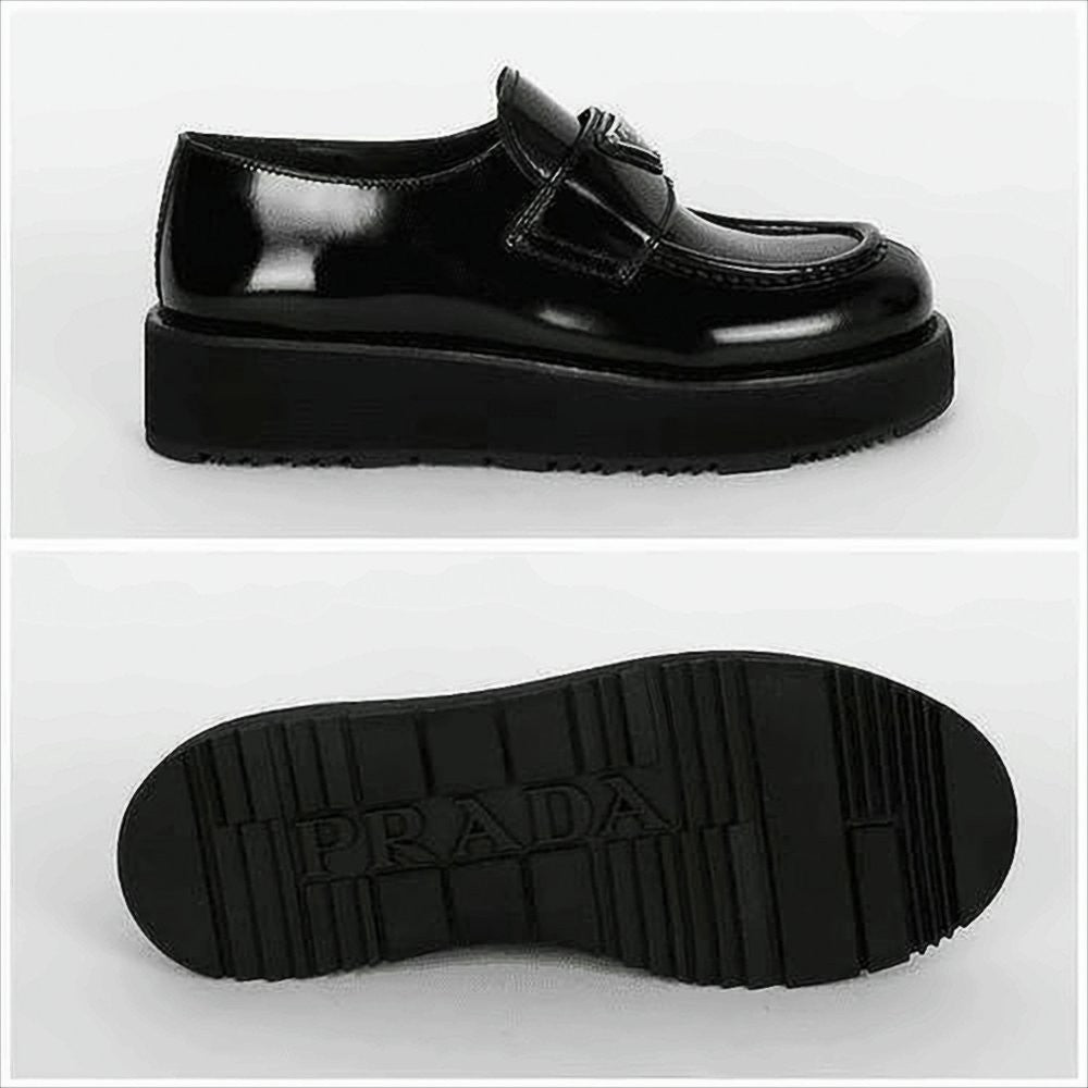 Prada Polished Leather Loafers With Triangular Metal Logo
