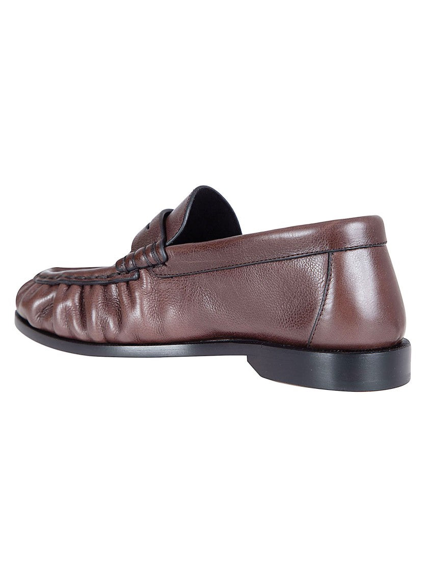 Saint Laurent Moccasin-Style Flat Shoes With Hand-Stitched Detail And Metal Emblem