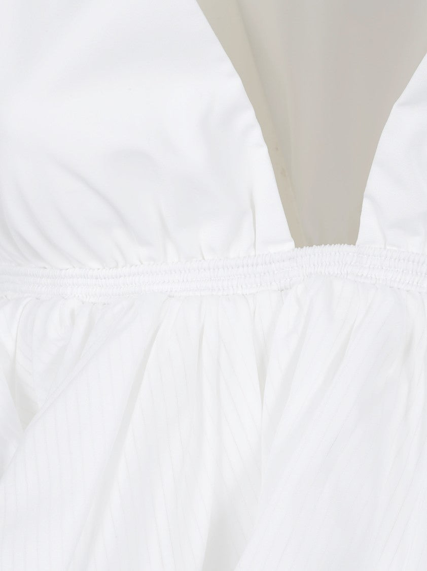 Alaïa Cropped Peplum Top With Deep V-Neck And Ruffled Hem