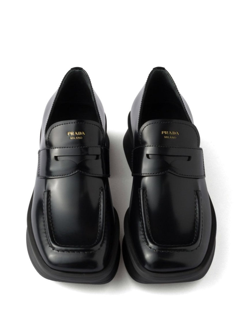 Prada Sole Black Flat Shoes With Glossy Finish And Modern Strap