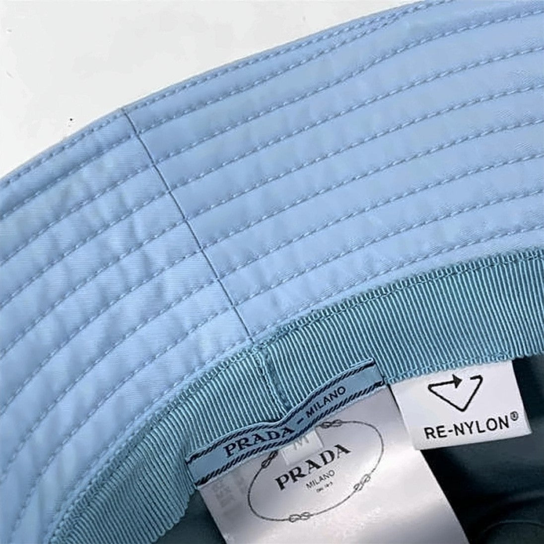 Prada Nylon Bucket Hat With Triangular Logo Plaque