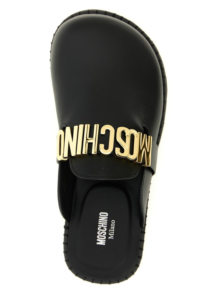 Moschino Closed-Toe Leather Sabots With Metal Logo Strap
