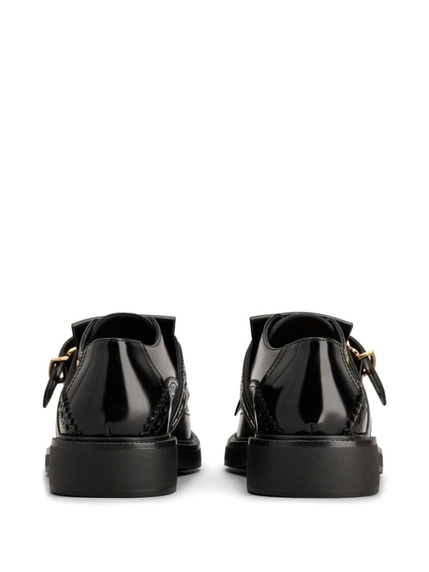 Tod's Elegant Black Shoes With Decorative Buckle And Fringe Detail