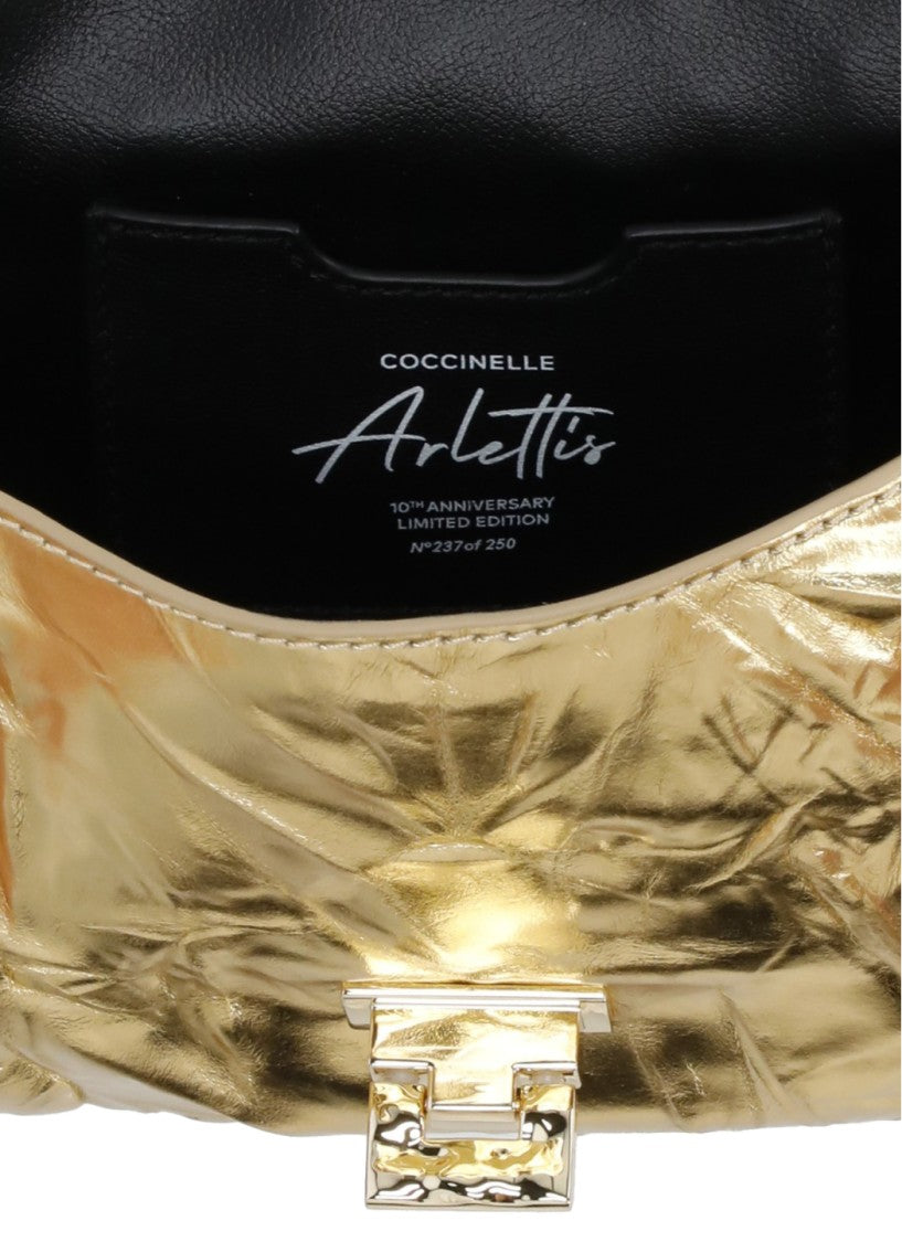 Coccinelle Droplet Bag In Shiny Gold Metallic Leather With Adjustable Strap