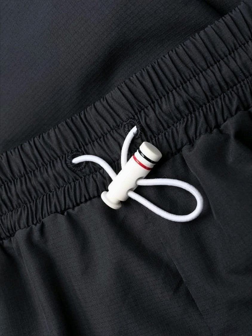 Thom Browne Sleek Black Training Jogger Pants With Distinctive Stripes