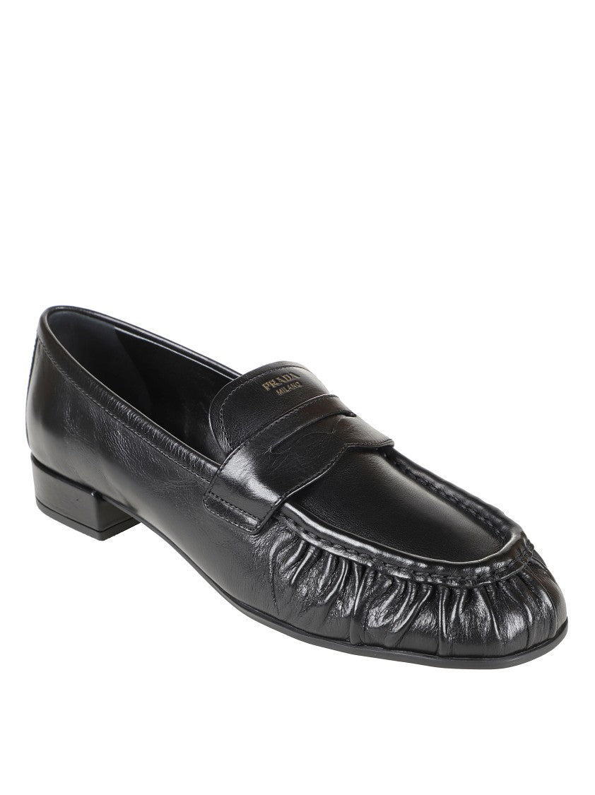 Prada Rounded Toe Loafers With Textured Detailing And Low Block Heel