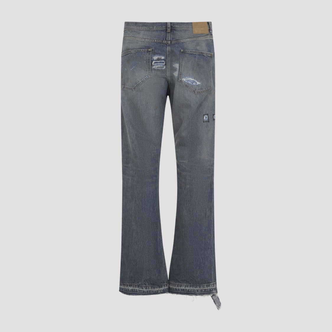 Enfants Riches Déprimés Faded Blue Distressed Jeans With Flared Leg And Asymmetrical Hem