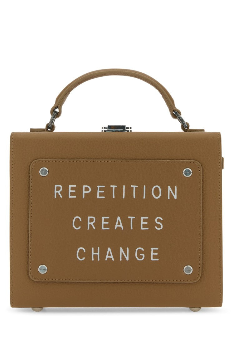 Meli Melo Structured Leather Handbag With Inspirational Embossing