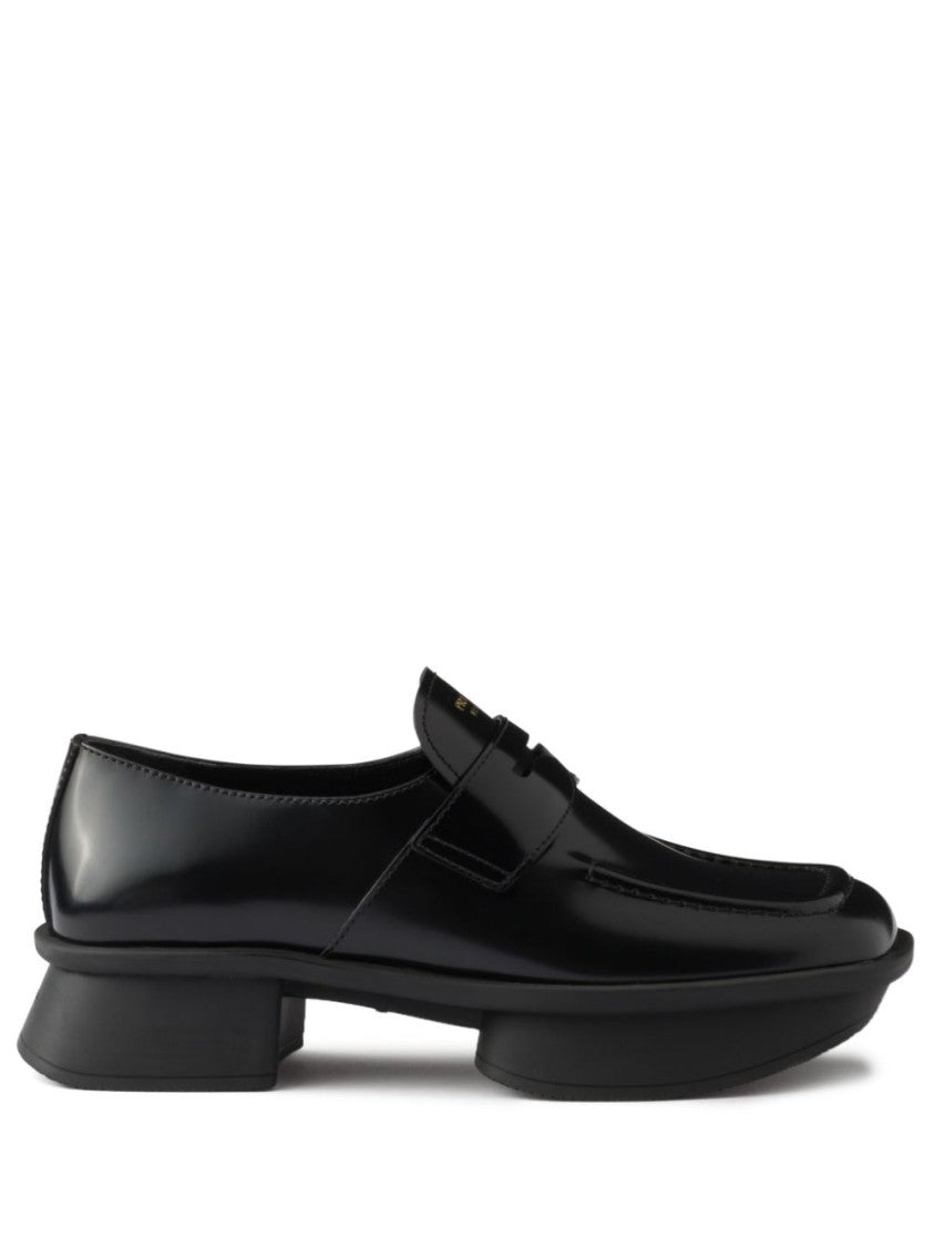 Prada Sole Black Flat Shoes With Glossy Finish And Modern Strap