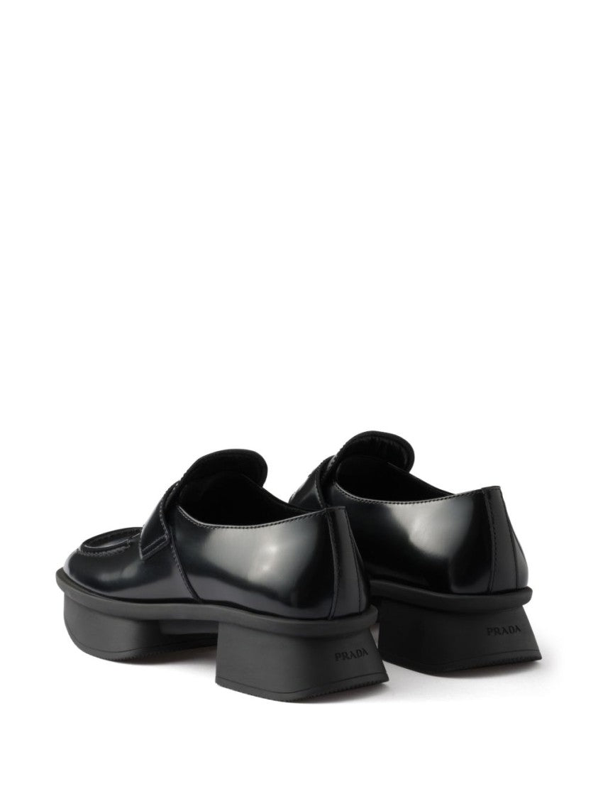 Prada Sole Black Flat Shoes With Glossy Finish And Modern Strap