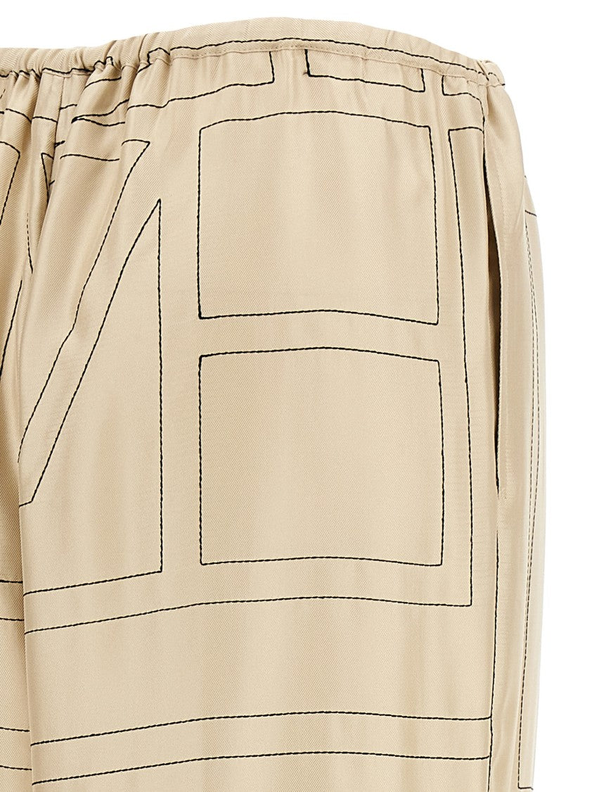 Totême Silk Twill Trousers With Monogram Embroidery