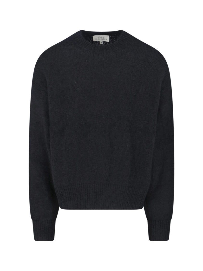Studio Nicholson Minimalist Black Sweater With Round Neckline And Timeless Appeal