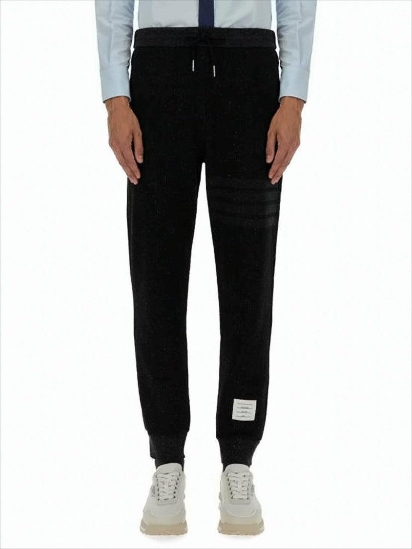 Thom Browne Tapered Jogger Pants With Ribbed Cuffs And Subtle Stripes