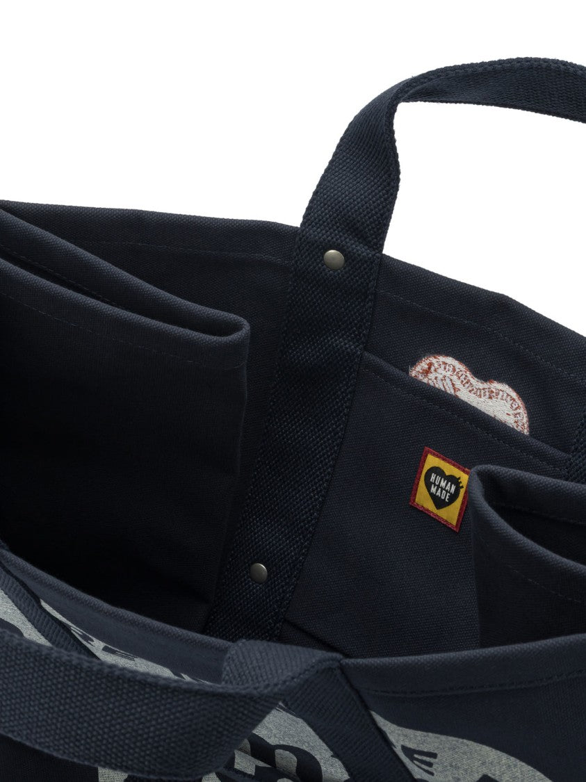 Human Made Durable Canvas Travel Bag With Heart Motif And Integrated Pocket
