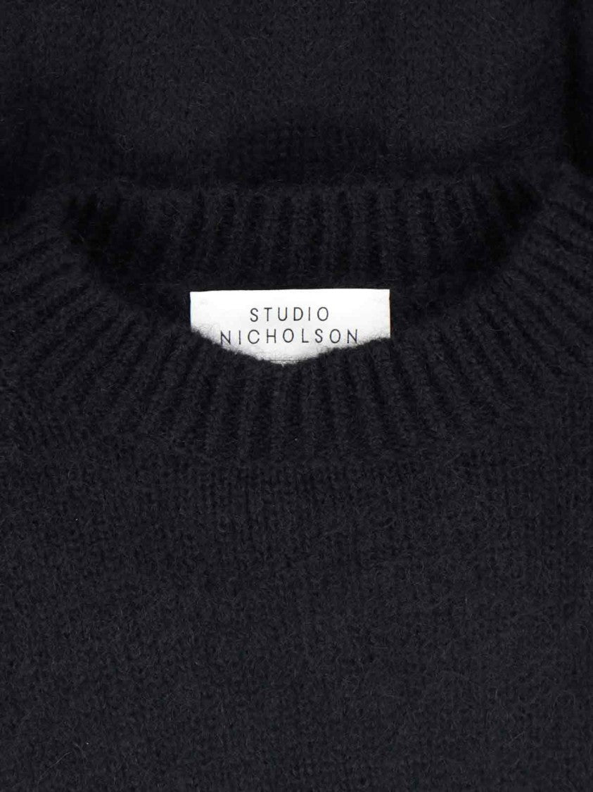 Studio Nicholson Minimalist Black Sweater With Round Neckline And Timeless Appeal