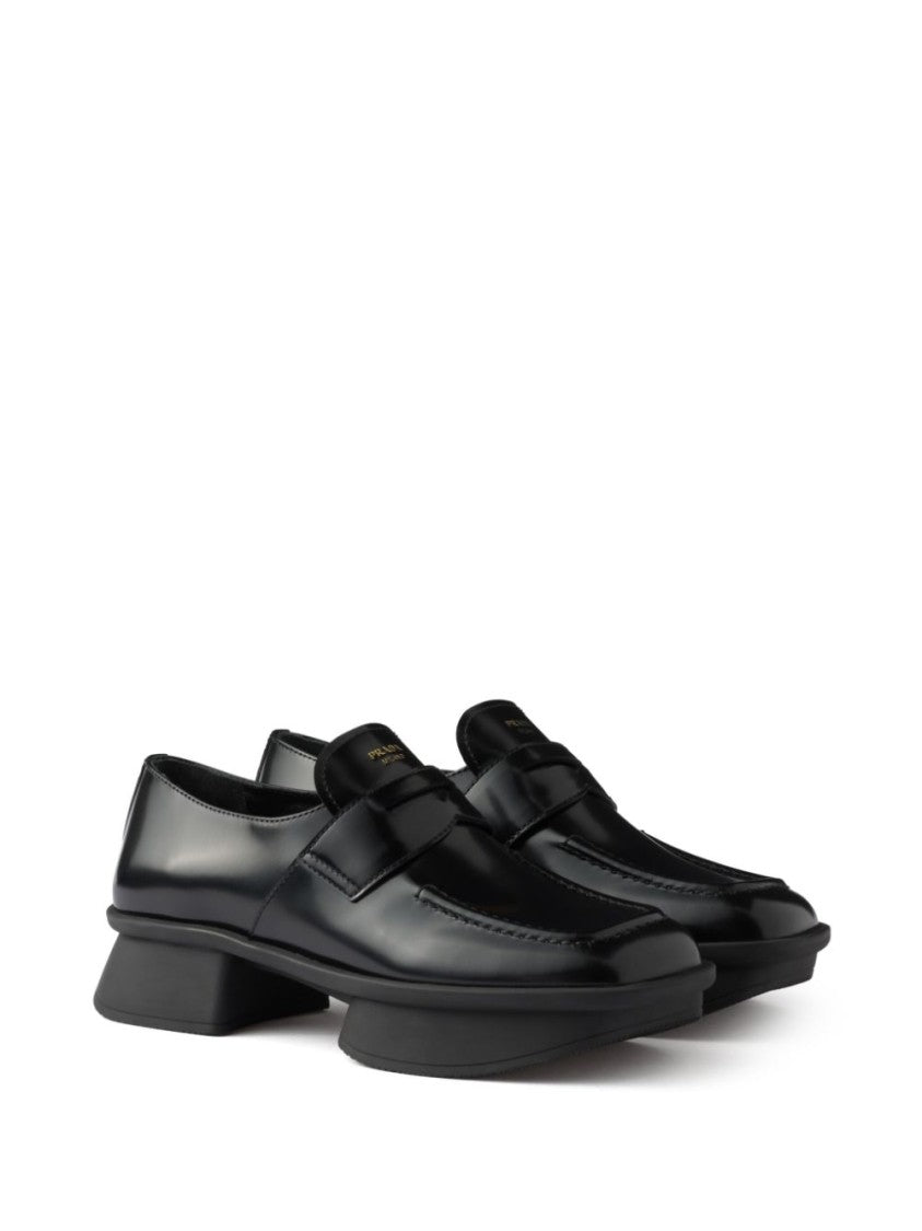 Prada Sole Black Flat Shoes With Glossy Finish And Modern Strap