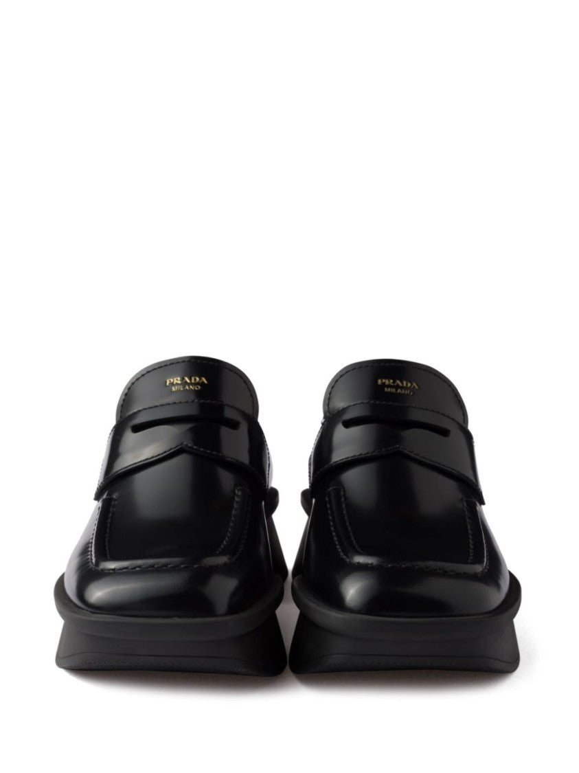 Prada Sole Black Flat Shoes With Glossy Finish And Modern Strap