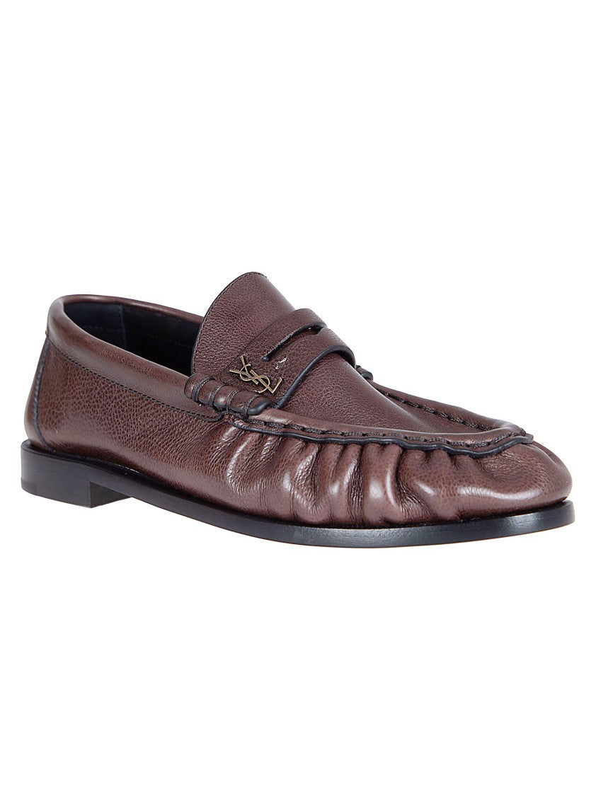 Saint Laurent Moccasin-Style Flat Shoes With Hand-Stitched Detail And Metal Emblem
