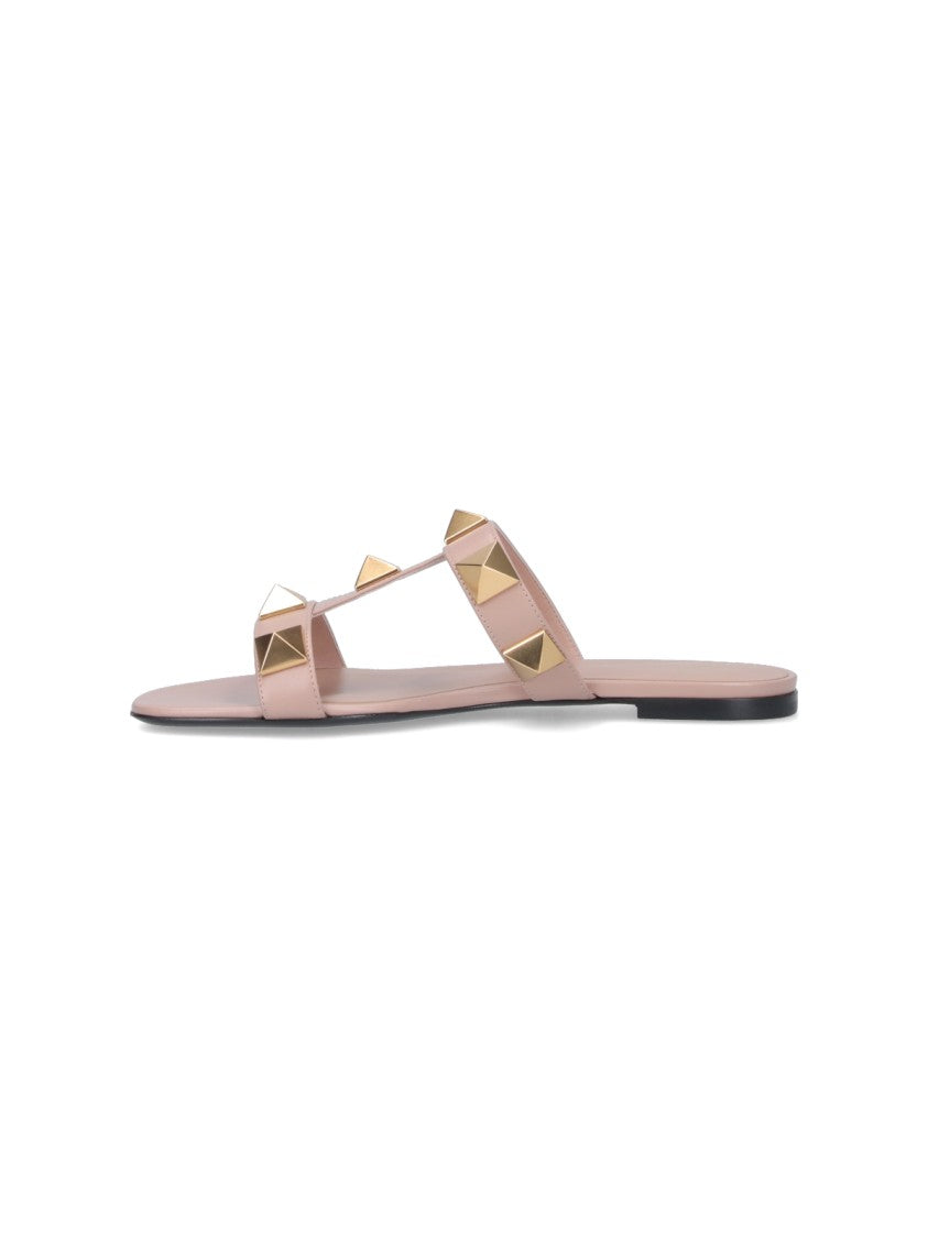 Valentino Garavani Minimalist Pink Flat Sandals With Pyramid Gold Studs