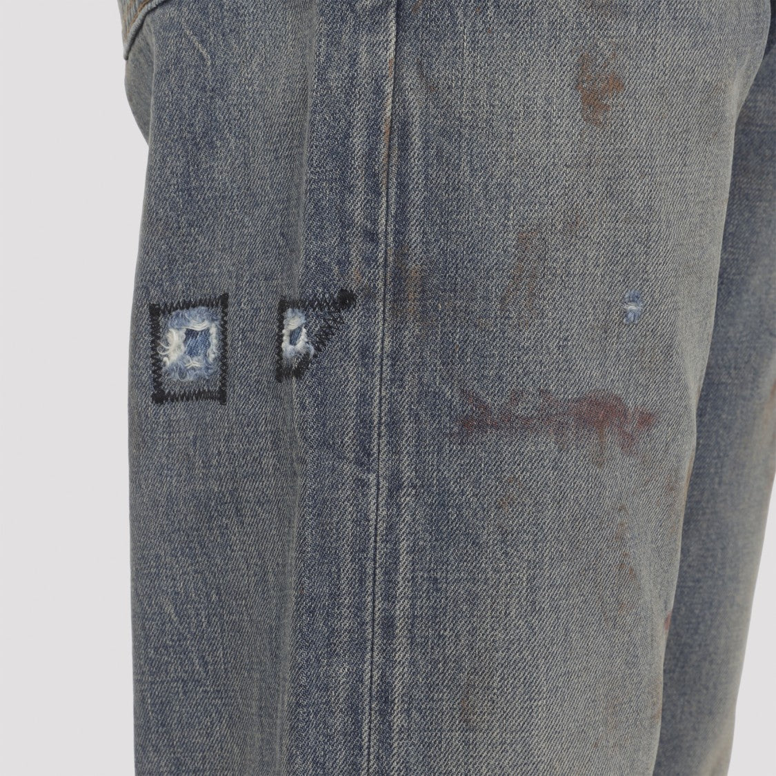 Enfants Riches Déprimés Faded Blue Distressed Jeans With Flared Leg And Asymmetrical Hem